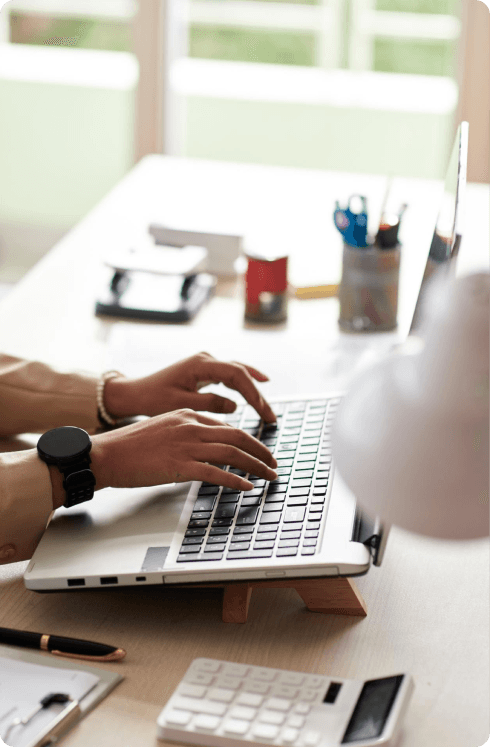 Professional working on a laptop at a desk