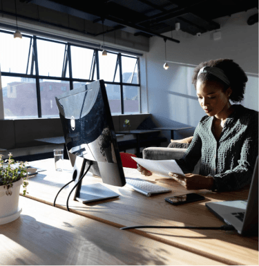 Smiling professional at a desk with a laptop