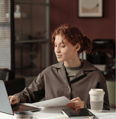 Remote worker at a desk in a bright office with large windows