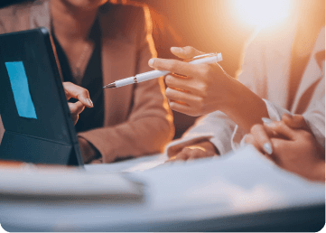 Hands pointing at a tablet during a hiring discussion