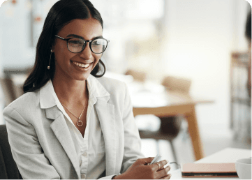 Professional smiling in an office while reviewing candidates
